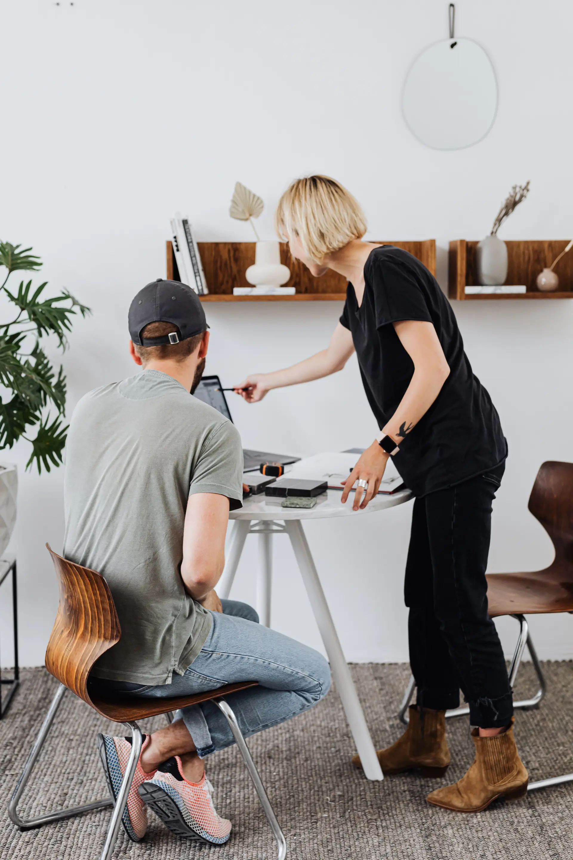 Interior architects examining custom joinery maquettes in studio